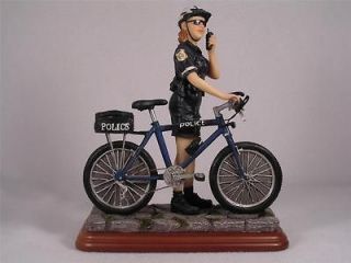 Blue Hats Of Bravery By Vanmark Park Duty Female Officer on Bike 