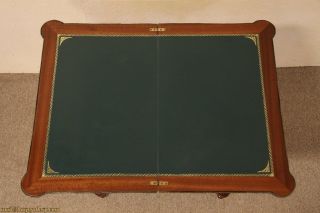 vintage game table has a flip and swivel top with inlaid marquetry