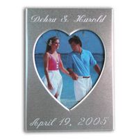 This brushed sliver metal place card frame holds a 2” x 3” photo