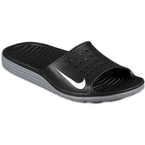 The Nike Solarsoft Slide features a soft, injected thermoplastic