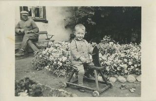 Smiling boy on wooden toy rocking horse antique photo