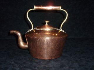 AN ANTIQUE DOVETAILED COPPER AND BRASS TEA KETTLE